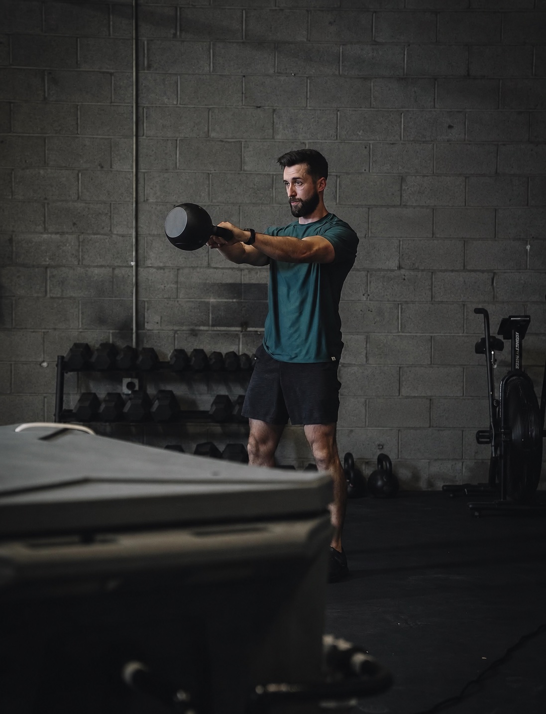 Caleb practicing a kettlebell swing in the gym